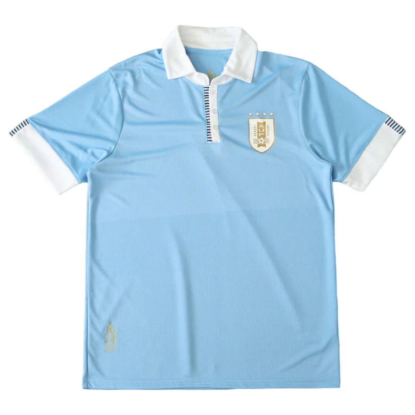 Photoroom-20240329-230727 Light blue polo shirt with white collar and cuffs featuring a crest badge on the chest, likely a sports jersey.