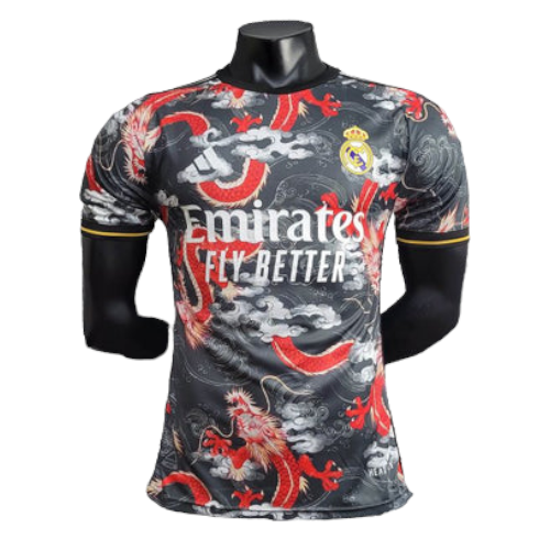 Real Madrid football jersey on a black mannequin, featuring red dragon graphics and the 'Emirates Fly Better' sponsor logo.