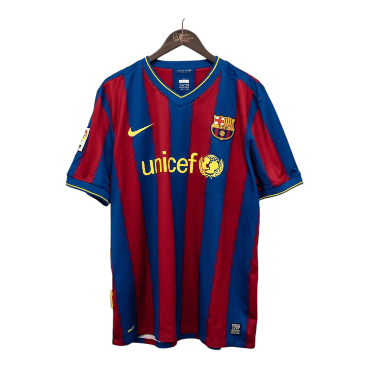 FC Barcelona home jersey hanging on a wooden hanger, blue and red stripes with UNICEF sponsor logos corner to corner.