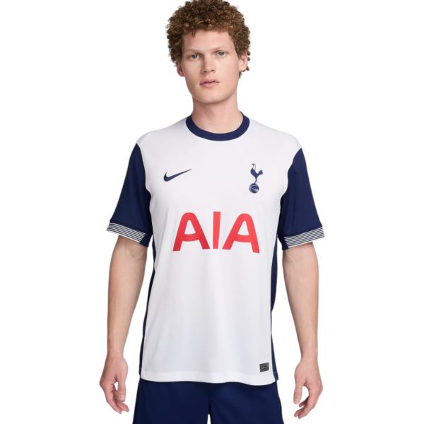Young man wearing a white Tottenham Hotspur football jersey with navy sleeves, Nike swoosh, and AIA sponsor.