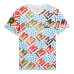 White graphic T-shirt with multicolored abstract shapes and blue dots; OM patch on left chest and Puma logo at the neckline.