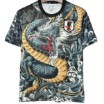 T-shirt featuring a detailed blue-gold dragon graphic, black neckline, and a Japan Football Association badge on the chest.