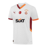 White soccer jersey with orange and maroon trim, featuring the Galatasaray crest, Puma logo, and SIXT sponsor on a white textured fabric.