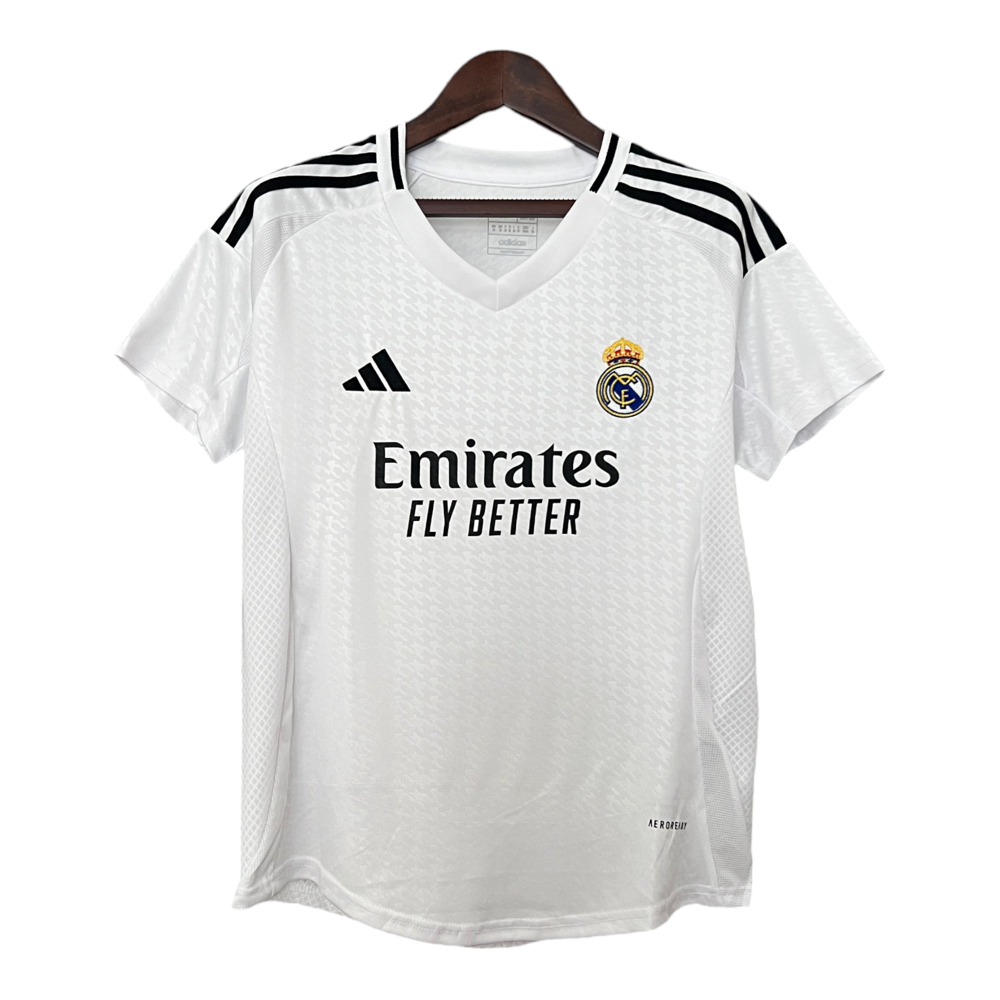 Photoroom-20240806-055513 White Real Madrid football jersey on a wooden hanger, featuring crest, Adidas logo, and Emirates sponsor