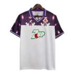 White Fiorentina soccer jersey with purple shoulders and collar, featuring a green 7UP sponsor logo on the chest.