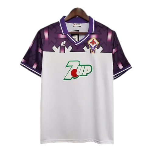 White Fiorentina soccer jersey with purple shoulders and collar, featuring a green 7UP sponsor logo on the chest.