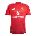 Manchester United red football jersey with Snapdragon sponsor and white Adidas stripes on shoulders and chest crest.