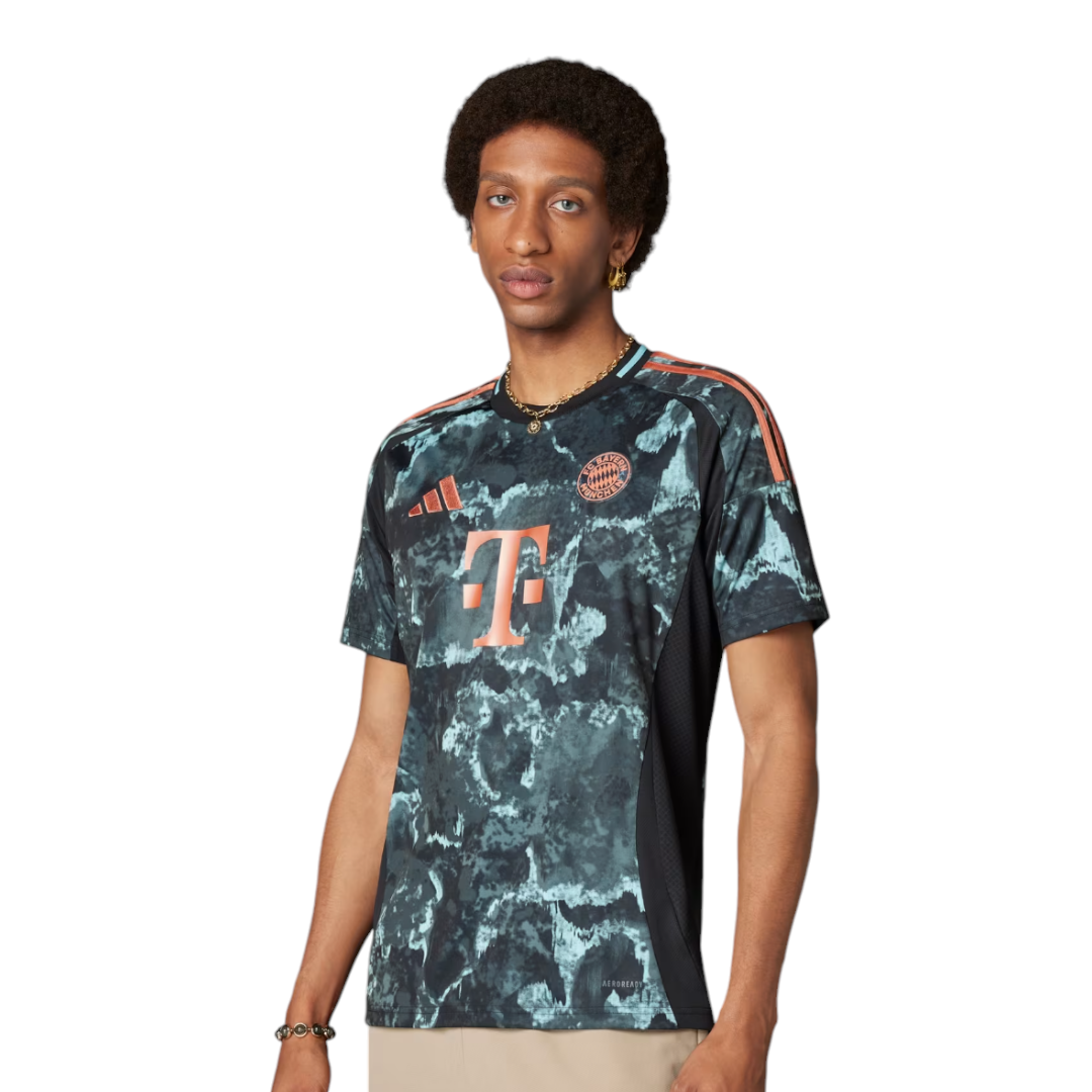 Photoroom-20240815-074752 Male model wearing a blue‑green marbled Bayern Munich football jersey with orange Adidas logo on chest and orange stripes on shoulders.