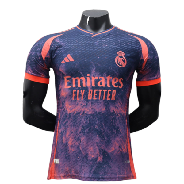 Purple–pink Real Madrid soccer jersey on a mannequin, featuring Emirates Fly Better sponsor and club crest on the chest.