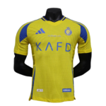 Yellow soccer jersey on a mannequin, blue shoulder panels, crest on left chest and 'K A F D' across front in blue text, ALDAWOODI sponsor patch at bottom right