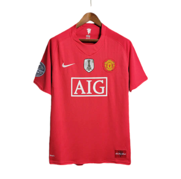Red Manchester United soccer jersey on a hanger featuring the AIG sponsor logo and team crest, with league patches on the sleeves.