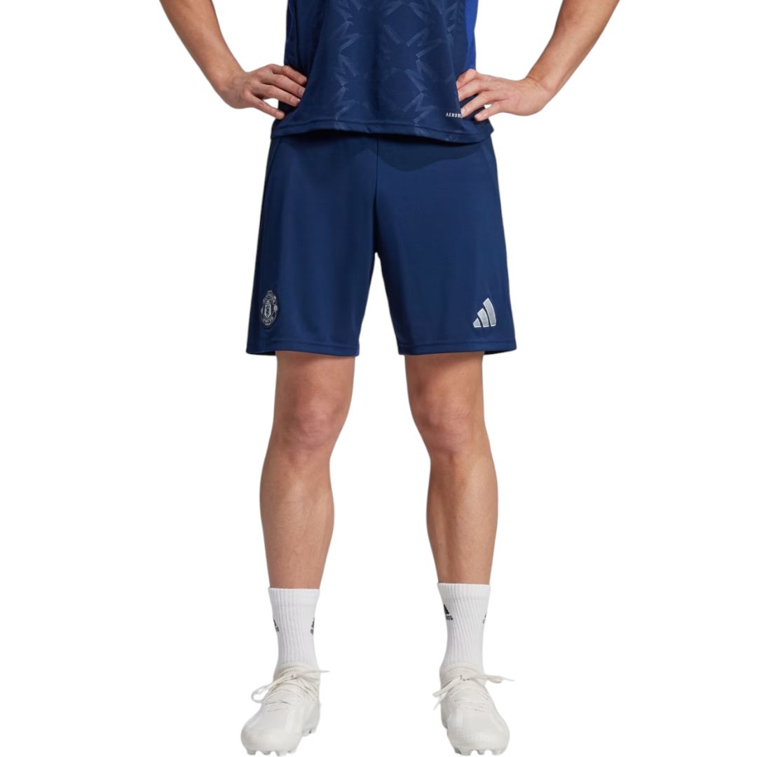 Photoroom-20241123-214710 | UAE SPORT STORE Athlete wearing navy athletic shorts with logos, white socks, and white cleats, standing with hands on hips.
