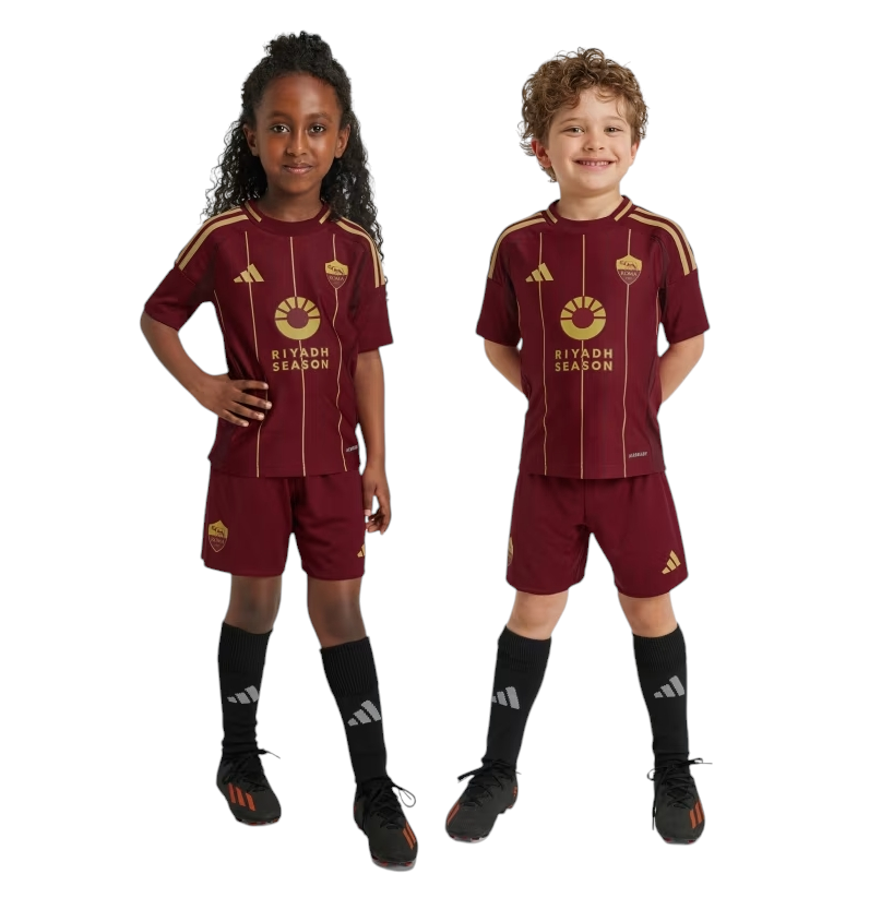 Photoroom-20241123-225643 Two children in maroon Riyadh Season soccer kits stand side by side, smiling.