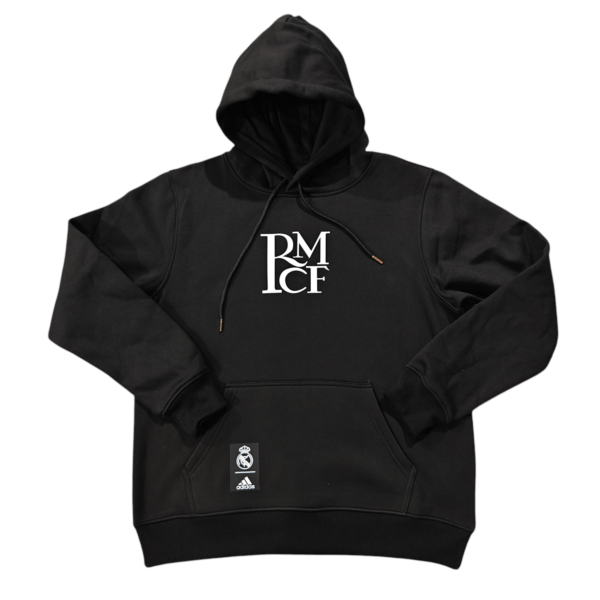 Black hoodie with a white stacked RM C E logo on the chest and Real Madrid tag hanging from the pocket area.