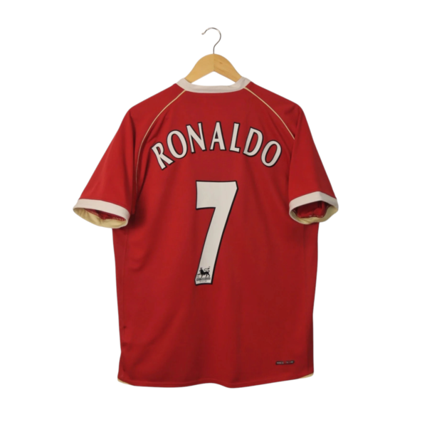 Red Ronaldo jersey on a wooden hanger, back shows the name 'RONALDO' and number 7.