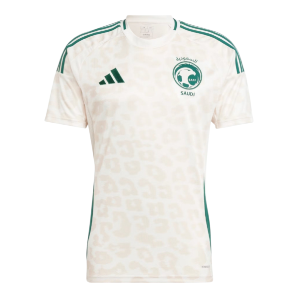 White Saudi Arabia football jersey with green Adidas logo and SAFF crest, short sleeves, subtle camo pattern.