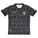Black sports jersey with gray lion pattern and a red-yellow crest on the chest, resembling a national team soccer jersey.
