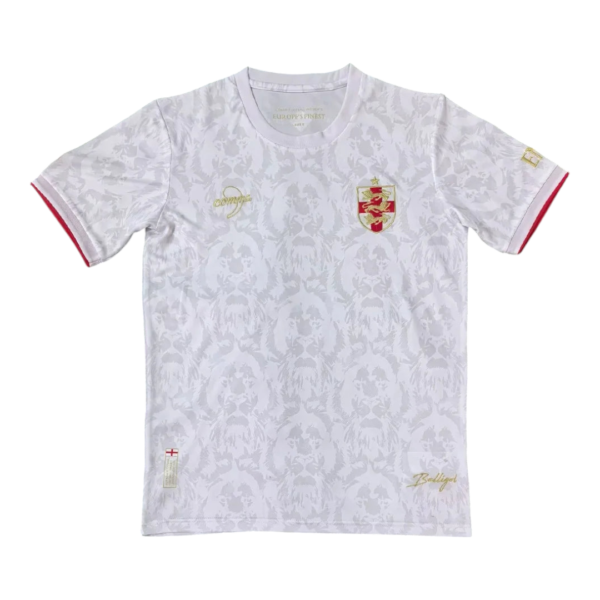 White T-shirt with a subtle grey floral/coat pattern, gold crest on the left chest and gold script details, red-trimmed sleeve cuffs.