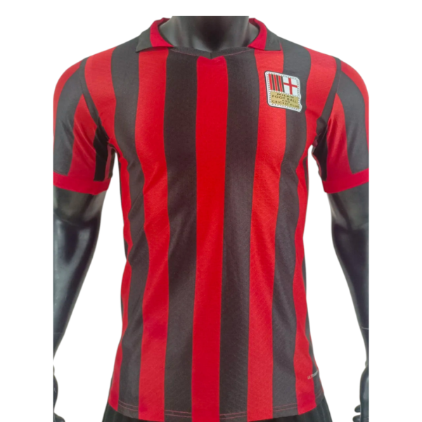 Red and black vertical-striped football jersey with a crest on the left chest, short sleeves, on a mannequin torso