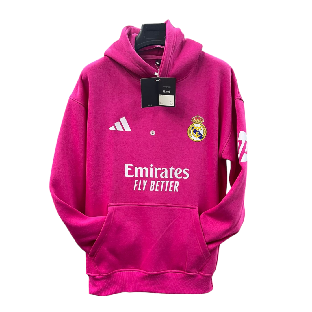 Photoroom-20250110-195141 | UAE SPORT STORE Pink Real Madrid hoodie on a hanger with Emirates Fly Better logo and club crest, front pocket visible, tag attached.