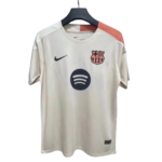White FC Barcelona football jersey on a hanger with Nike swoosh, club crest, and Spotify sponsor logo on the chest, pink shoulder panel detail.