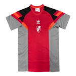 Red center-panel athletic jersey with gray side panels and black shoulders, featuring the Adidas logo and a club crest on the chest.