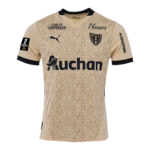 Beige soccer jersey with a repeating crest pattern, featuring a club crest on the chest and large Auchan logo across the front.