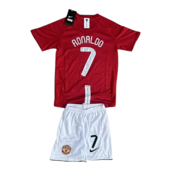 Manchester United football kit: red jersey with 'RONALDO' and number 7, paired with white shorts featuring the club crest and Nike swoosh.