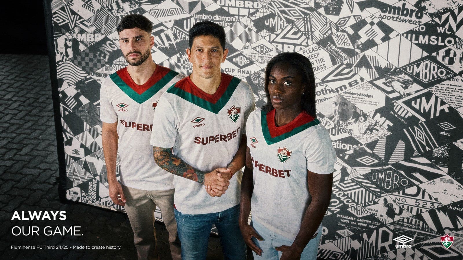 Py5Xx04dNEY038D | UAE SPORT STORE Three soccer players in white jerseys with red and green chevrons stand together; the center player shakes hands with a teammate while the others look at the camera against a patterned wall.