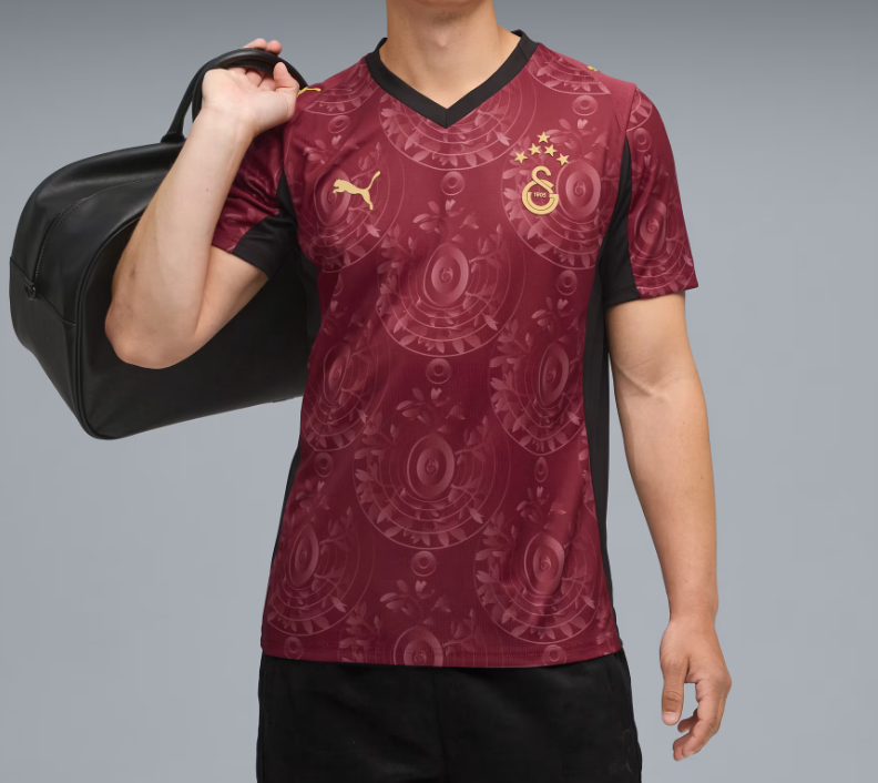 Q1 | UAE SPORT STORE Person wearing a maroon Galatasaray football jersey with crest and Puma logo, carrying a black gym bag over the shoulder.