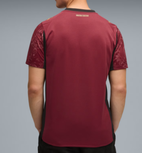 Q3 | UAE SPORT STORE Back view of a maroon athletic jersey with black side panels, worn by a person; small gold text on the upper back reads MEKTEB-ISULTANI.