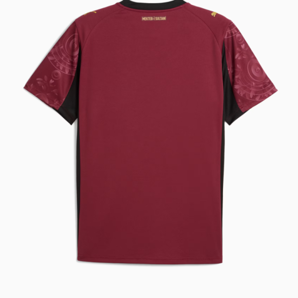 Back view of a maroon athletic jersey with black side panels and patterned sleeves; small gold text near the collar reads 'MEKTEB I SULTANI'.