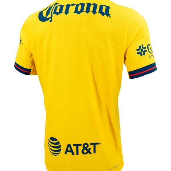 Back view of a bright yellow sports jersey with blue branding: Corona across the upper back and AT&T logo at the lower back; navy and red trim on sleeves.