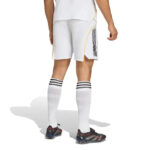 RMCFMP0301_05 | UAE SPORT STORE Back view of a player wearing white soccer shorts with yellow piping, white knee-length socks with black stripes, and dark cleats.
