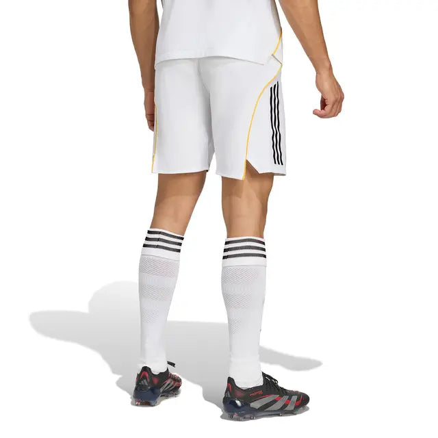 RMCFMP0301_05 | UAE SPORT STORE Back view of a player wearing white soccer shorts with yellow piping, white knee-length socks with black stripes, and dark cleats.