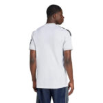 Back view of a man wearing a plain white short-sleeve shirt with black stripes on the shoulders, standing against a white background.