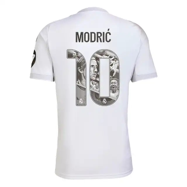 RMCFMZ0899_modric | UAE SPORT STORE White Real Madrid football jersey shown from the back, with the name Modrić and number 10 filled with a grayscale collage.