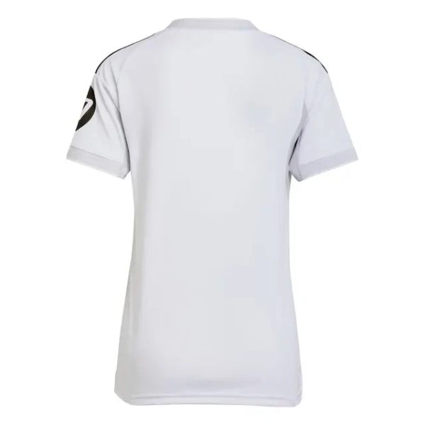 White short-sleeve sports jersey viewed from the back, with black shoulder seams and a circular logo on the left sleeve.