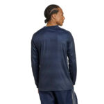 Back view of a person wearing a navy long-sleeve athletic top and matching shorts, braid-style hair visible from the side.