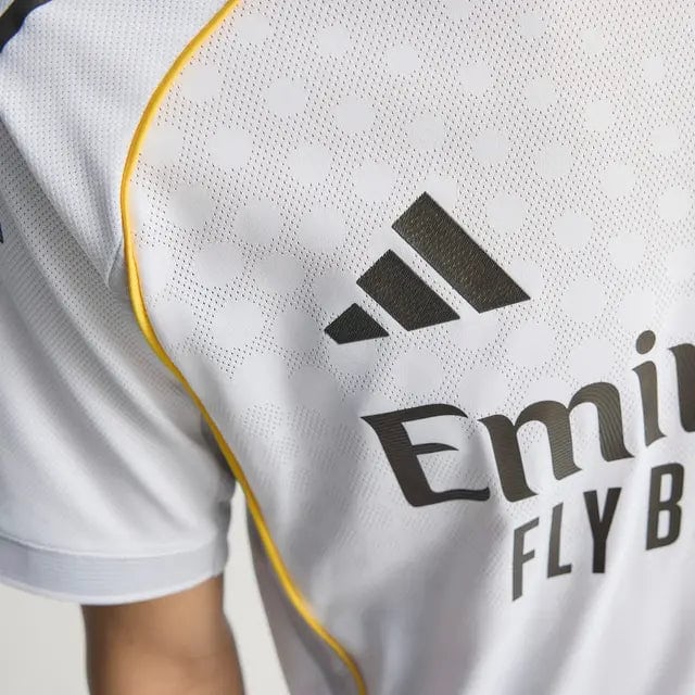 RMCFMZ0919_03 | UAE SPORT STORE Close-up of a white athletic jersey with yellow piping, featuring the Adidas logo and 'Emirates Fly Better' text.