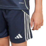 Close-up of a person wearing navy Adidas athletic shorts with white side stripes and logo, paired with a matching navy top showing Aeroready text.