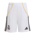 White Real Madrid football shorts with yellow piping, black side stripes, Real Madrid crest and Adidas logo visible on the left leg