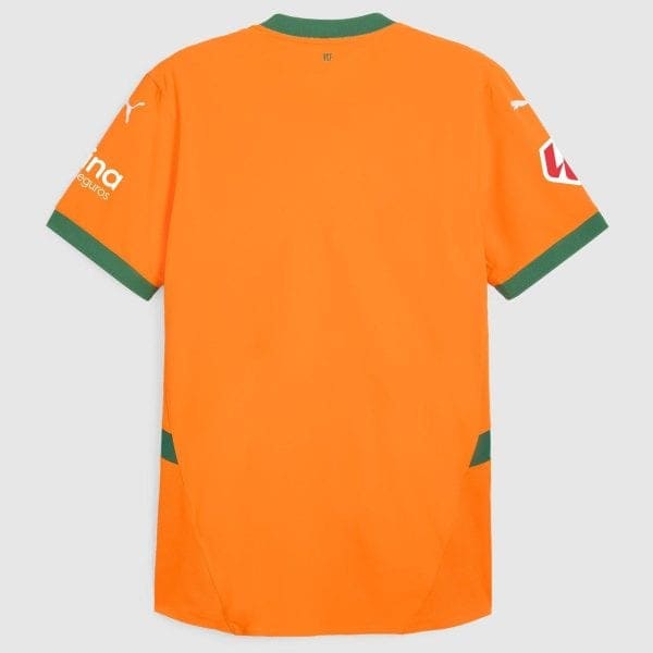 Bright orange sports jersey back view with green ribbed cuffs and neckline, logo patches on sleeves visible