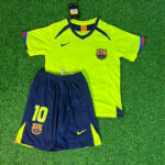 RonaldinhoGauchoBarcelona20052006GreenYellowRetroJerseyTrikotMaillot | UAE SPORT STORE FC Barcelona youth football kit on grass: neon yellow jersey with crest and Nike logo, navy shorts with number 10 and club crest.