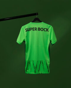 Rs2Rwg0ZzaheQpd | UAE SPORT STORE Bright green short-sleeve sports jersey hanging on a black hanger against a matching green background; the back shows the bold text 'SUPER BOCK'.
