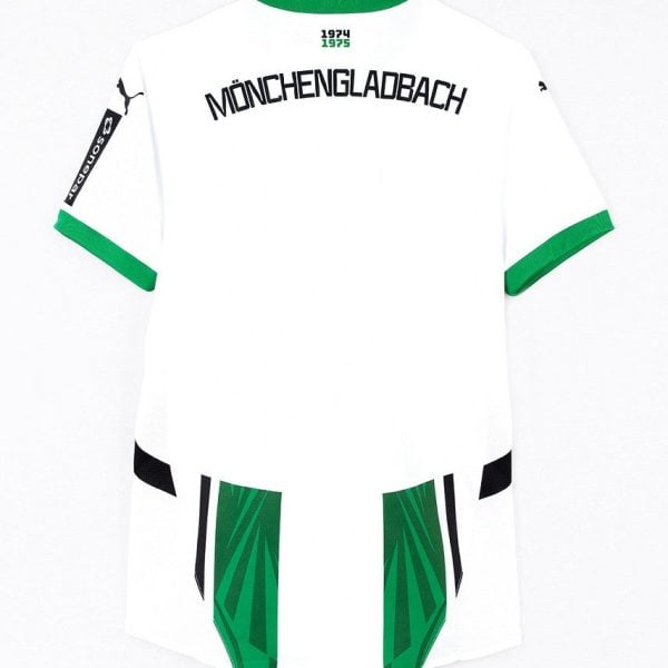 Back view of a white Borussia Mönchengladbach jersey with green trim and bold 'MÖNCHENGLADBACH' lettering across the upper back, green accents, and green panels on the lower back.