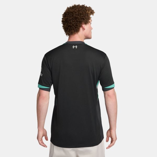 Back view of a person wearing a black athletic jersey with teal trim on the sleeves and a small white logo at the upper back against a light-gray background.