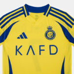 SSS2_ADJP0458_4067903561935_3 | UAE SPORT STORE Yellow soccer jersey with blue trim and stripes, Adidas logo, club crest, and 'KAFD' sponsor text on the front.