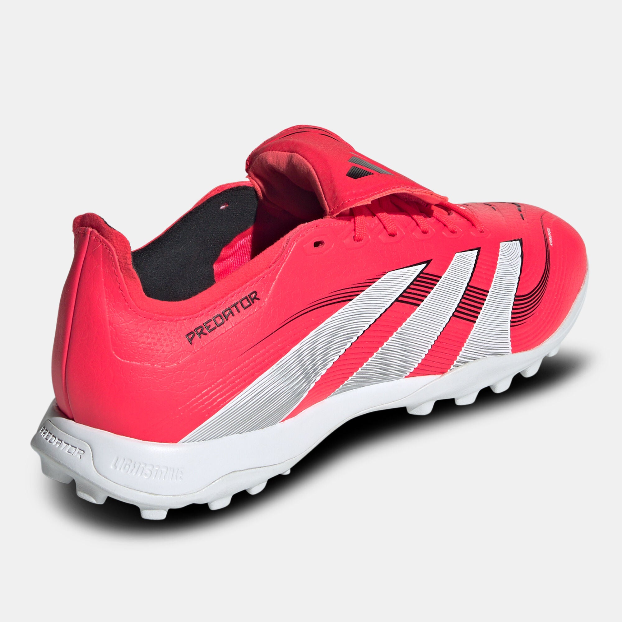 SSS2_ADJS0384_4067903835517_3 | UAE SPORT STORE Red athletic soccer shoe with white stripes, close-up of the side and sole.