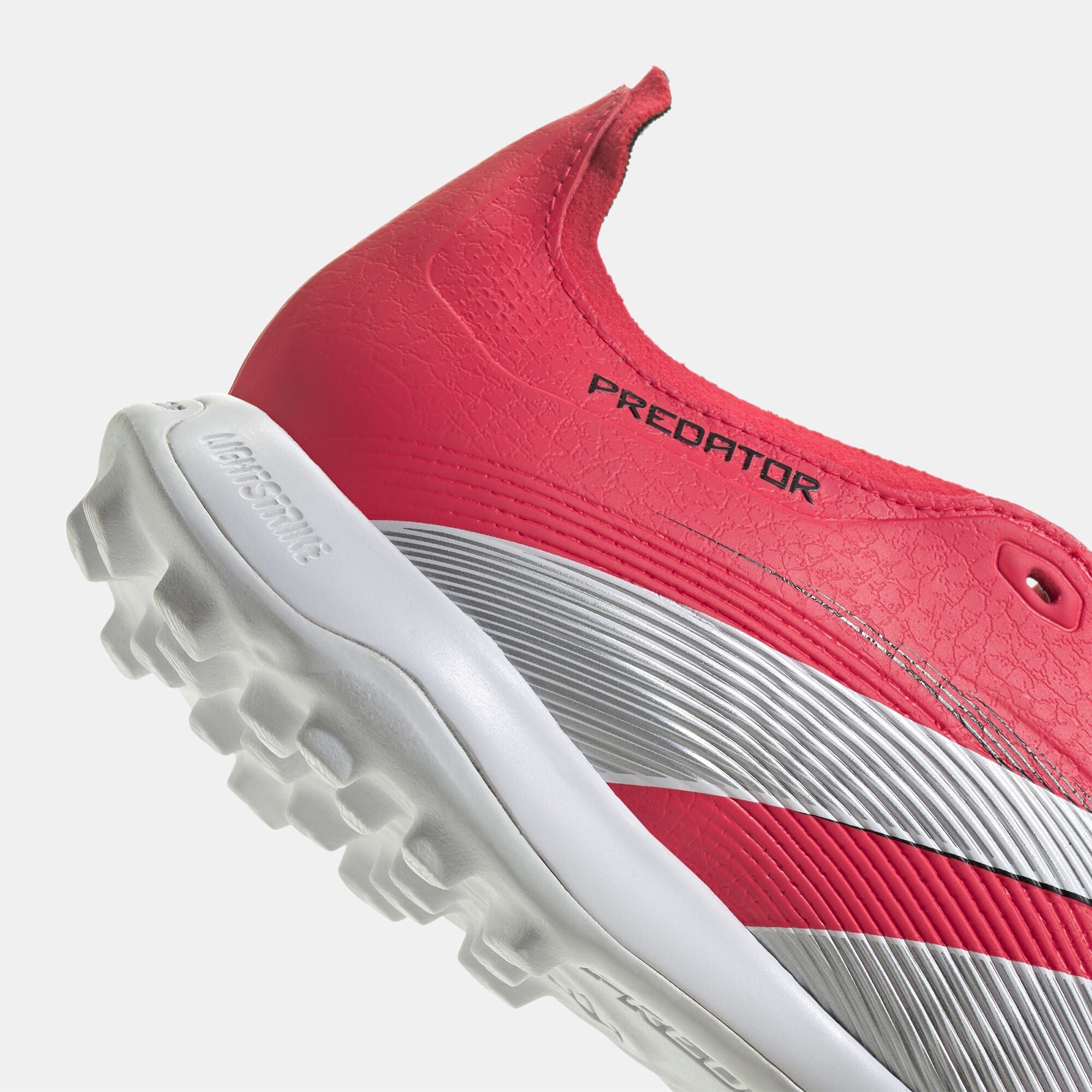 SSS2_ADJS0384_4067903835517_5 | UAE SPORT STORE Close-up of a pink athletic sneaker showing textured upper and white sole from a diagonal angle.